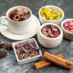 A variety of natural caffeine-free energy boosters including herbal tea and spices on a rustic background.