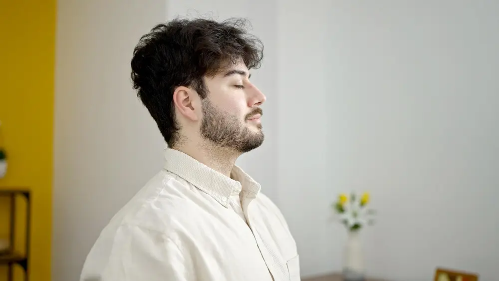 man practicing breathing techniques