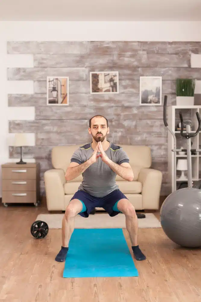 Man exercising on a yoga mat workouts-that-burn-the-most-calories-at-home guide 